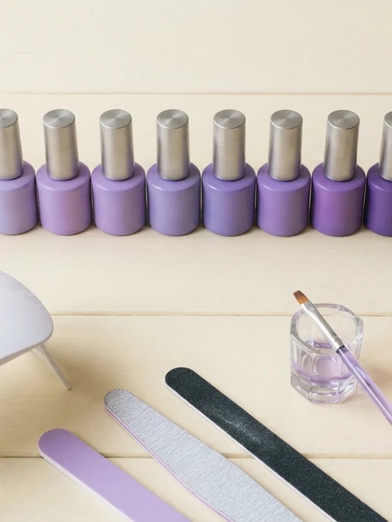 Nail artist's workstation with Lavender Violets gel polishes and LED lamp